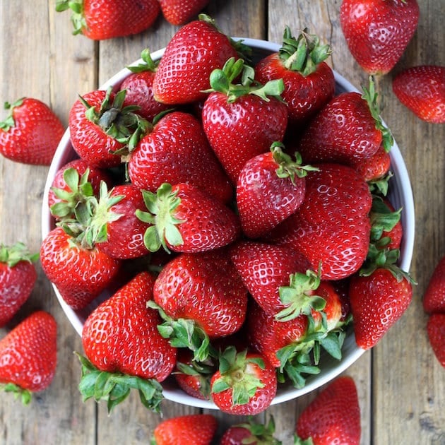 Bowl overflowering with fresh strawberries