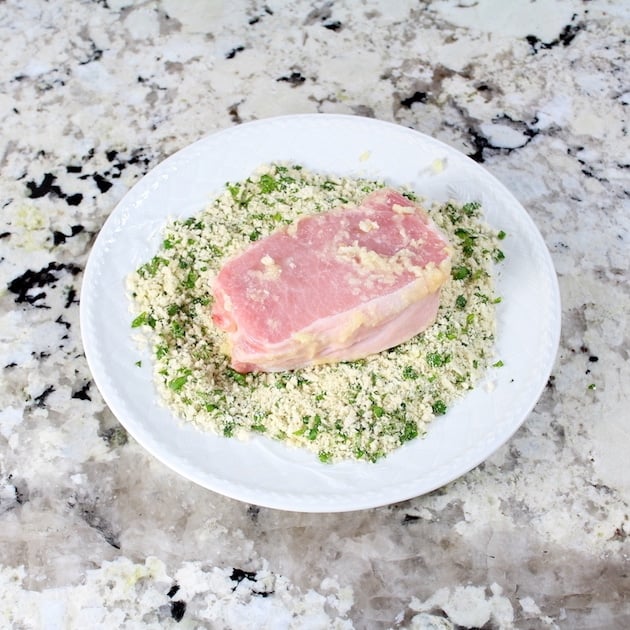 Coating a pork chop in bread crumbs