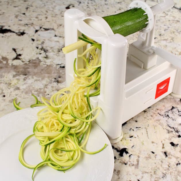 Zucchini being put through a Spiralizer to make zucchini noodles or zoodles 