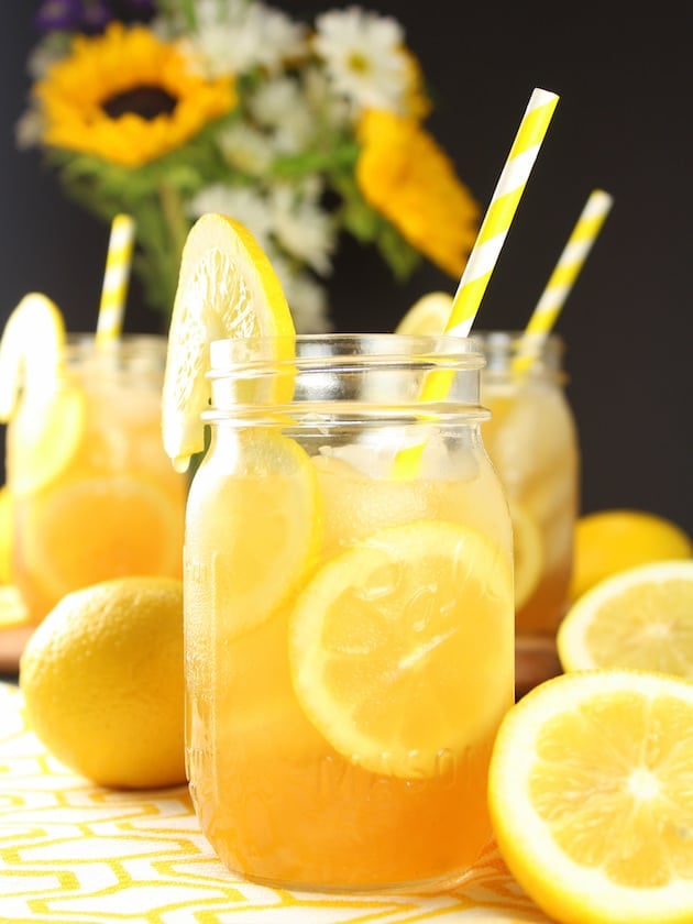 Loaded Lemon Iced Tea with lemon garnishes in mason jars