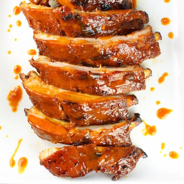 An over the top closeup photo of sliced grilled bbq baby back ribs.