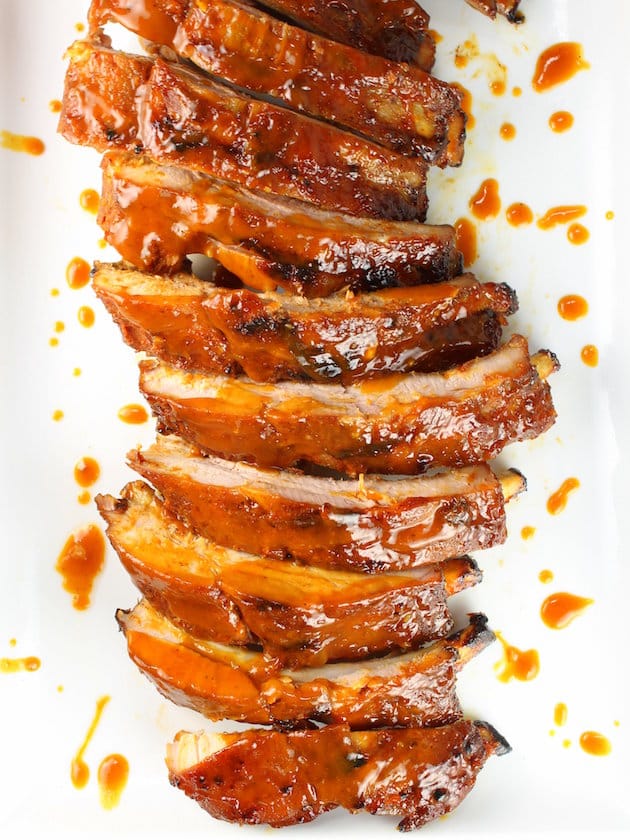 \"Secret Sauce\" BBQ Ribs Recipe - Sliced rack of ribs on platter, bird\'s eye view