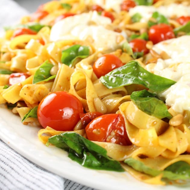 Close up Tagliatelle with Burrata, Tomatoes, and Pine Nuts