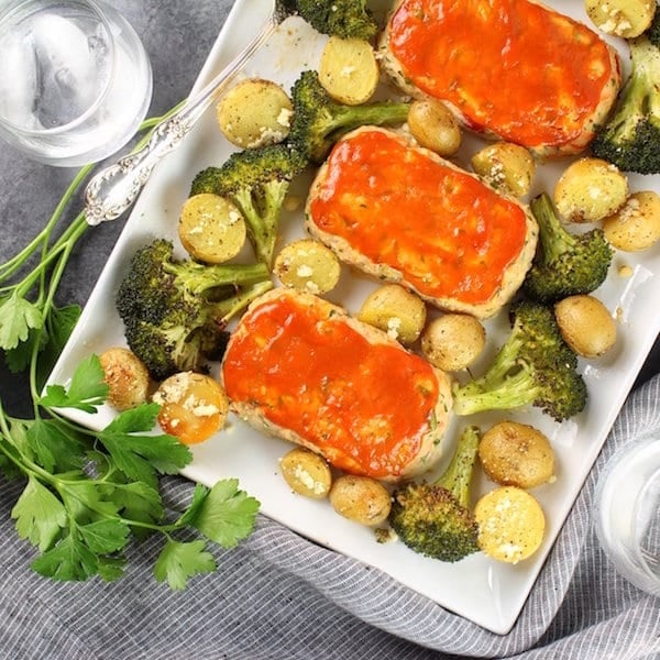 Turkey meatloaves on platter with broccoli and potatoes