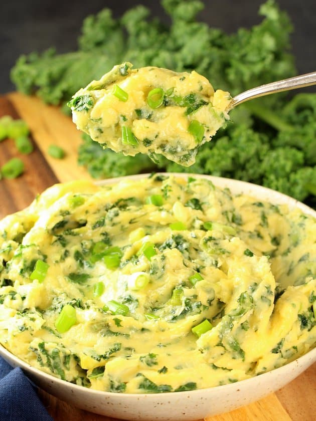 Spoon Over Dish of Cheesy Kale Mashed Potatoes