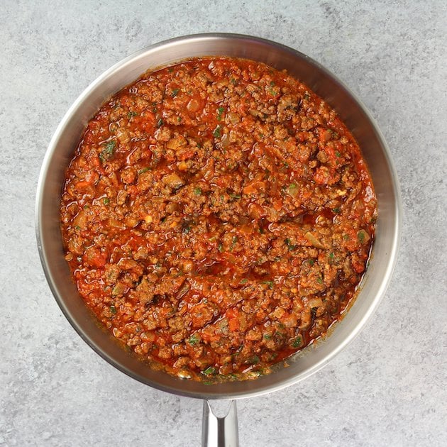 Stirring marinara into the beef mixture.