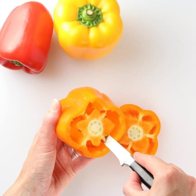 Coring an orange bell pepper