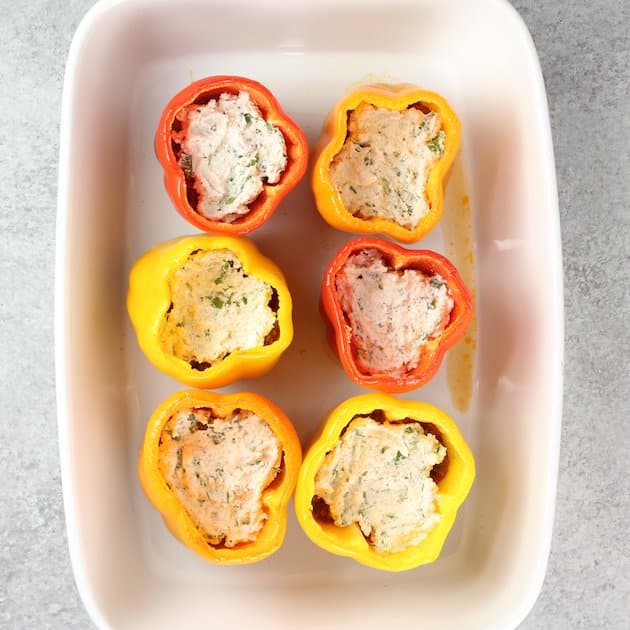 Stuffing ricotta cheese mixture into lasagna stuffed peppers