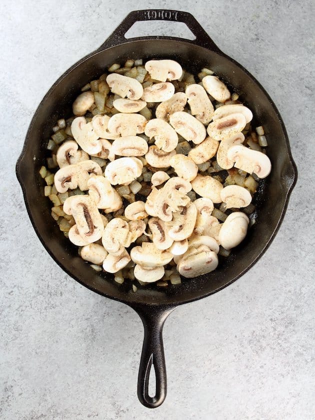 Adding sliced white mushrooms to Marsala Chicken Orzo Skillet