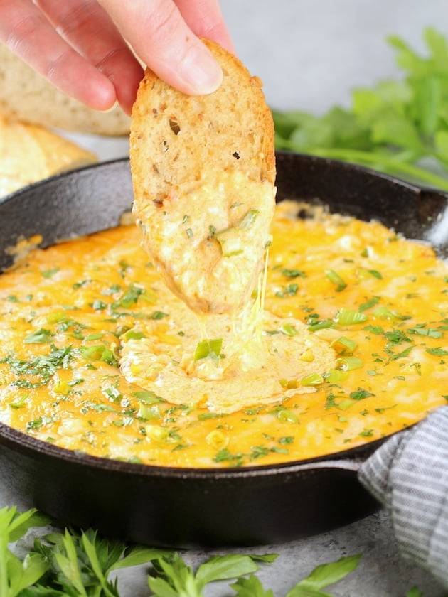 Dipping Bread into Cheesy Buffalo Shrimp Dip 