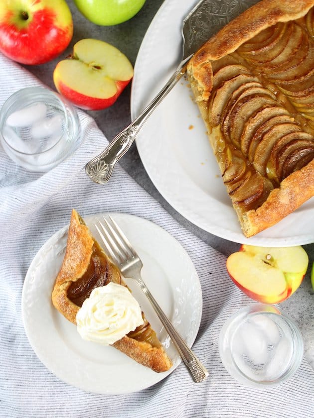 PIece of Salted-Butter Apple Galette on plate with fork and whipped cream
