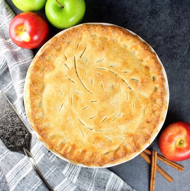 Caramel Apple Pie next to spatula and apples