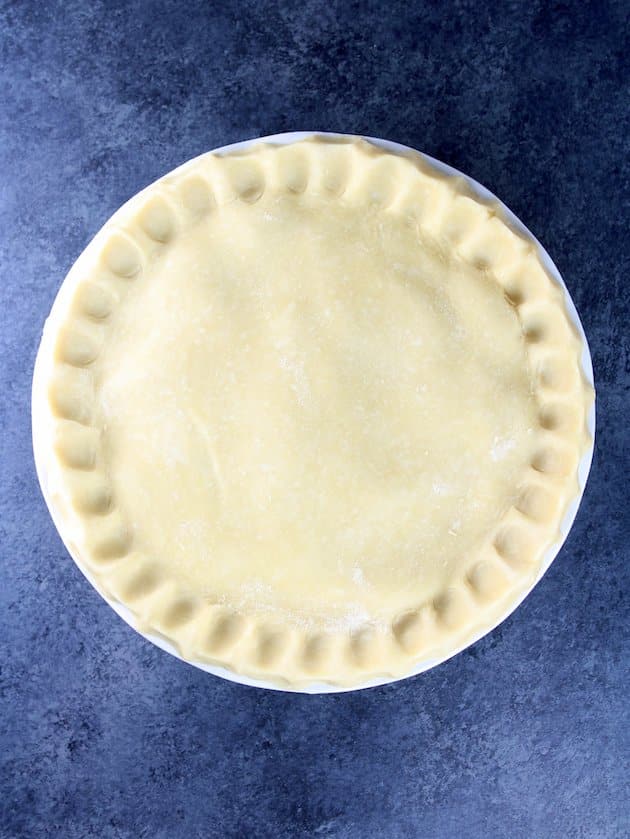 The pie with crimped edges before cooking.