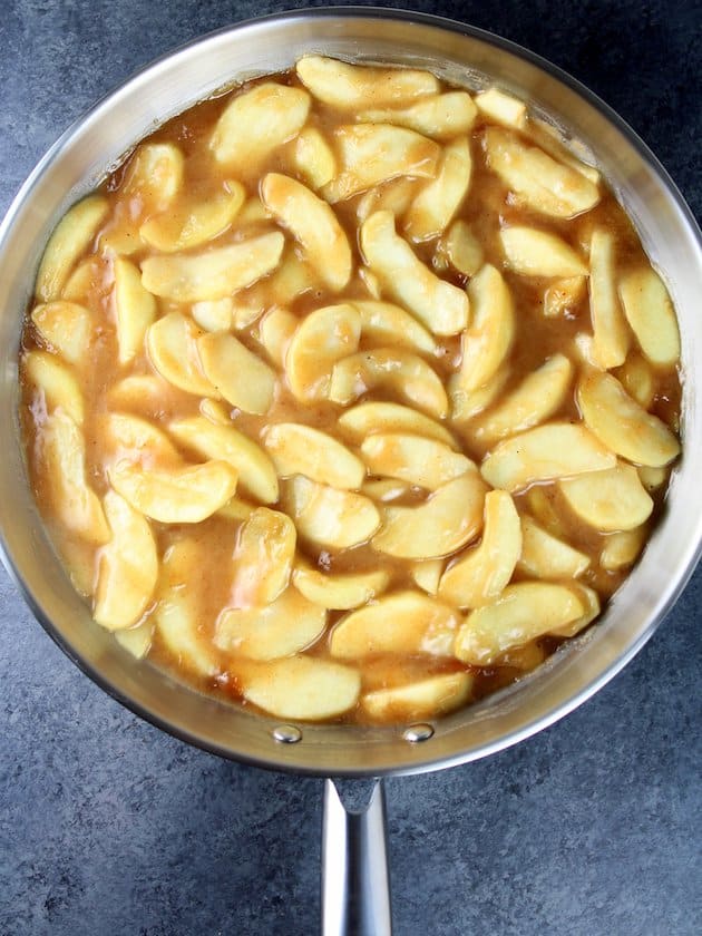 Apples sauteeing in caramel sauce.