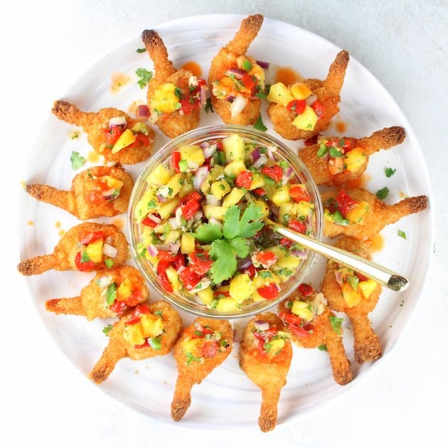 Full Plate of Firecracker Shrimp with glass bowl of pineapple relish