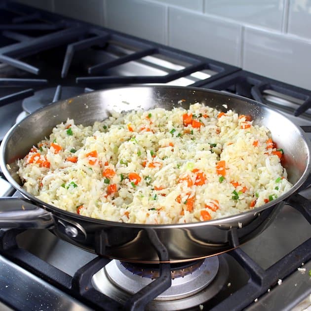A pan of food on a stove, with Rice and Cauliflower