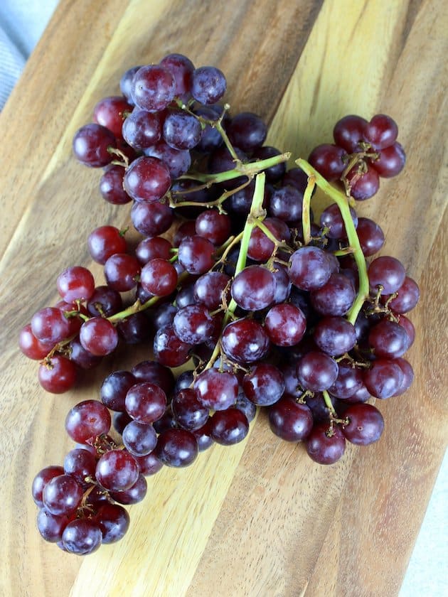 Fresh grapes on cutting board