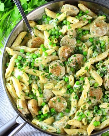 Saute pan of creamy chicken alfredo with penne and peas