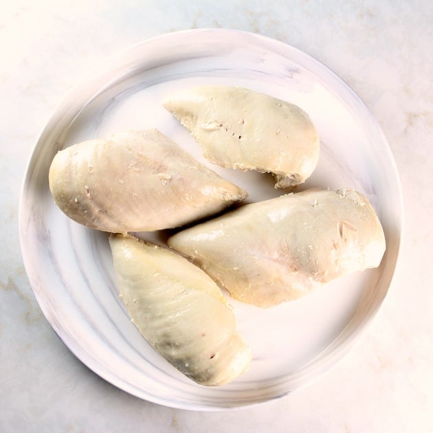 Poached chicken breasts on a plate