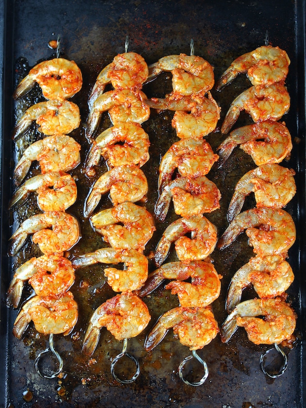 Skewered shrimp on cookie sheet ready to bake