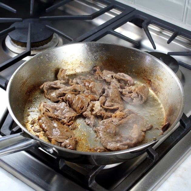 Steak cooking in saute pan