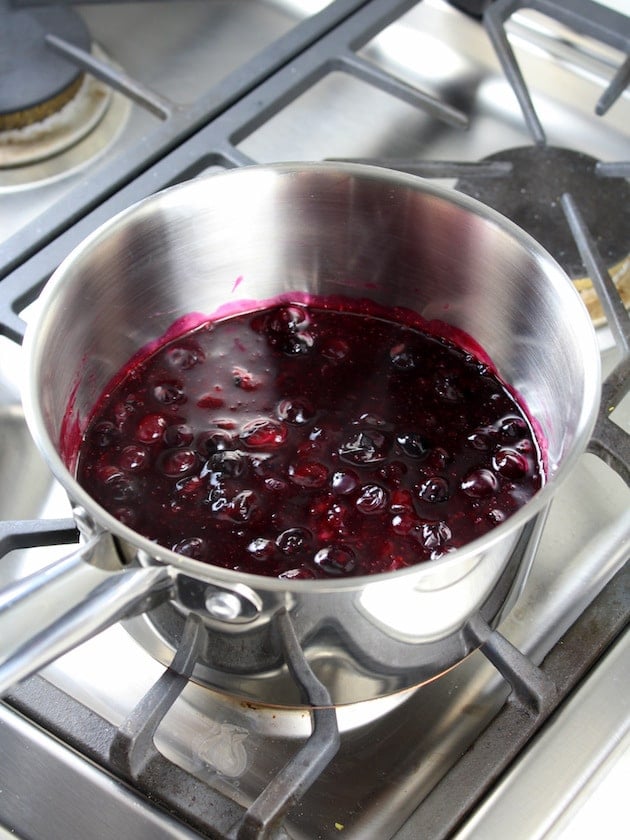 Blueberry sauce cooking in saucepan