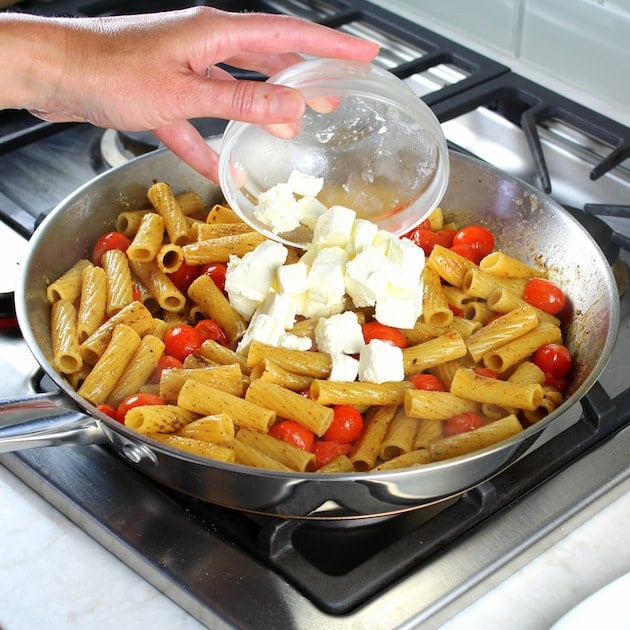 Cooking pesto chicken pasta on stovetop cream cheese and rigatoni