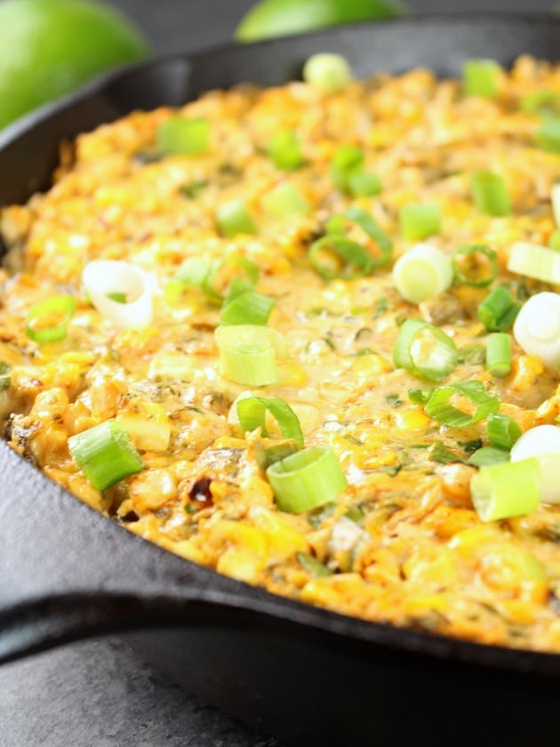 Close up of Smoky Poblano Corn Dip in a skillet with a spoon