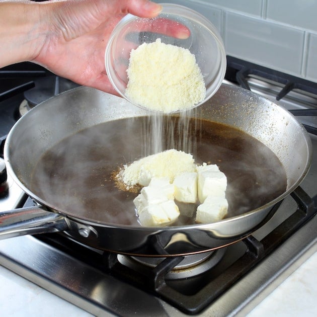 Adding cheese to saucepan