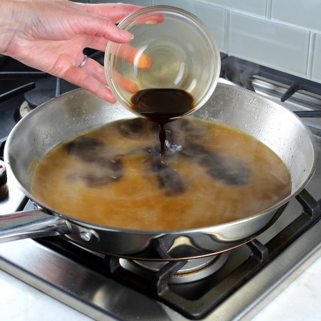 Adding ingredients to pan on stovetop