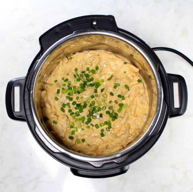 Instant Pot Jalapeño Popper Chicken  Dip in instant pot with chives