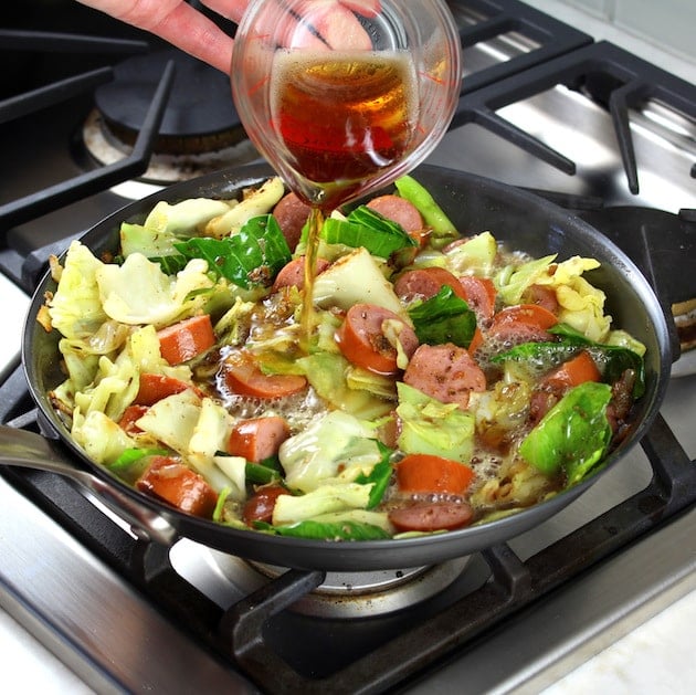  Beer Pouring Into Pan of cabbage and kielbasa