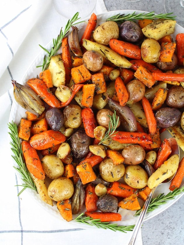 Lots of roasted root vegetables on platter.