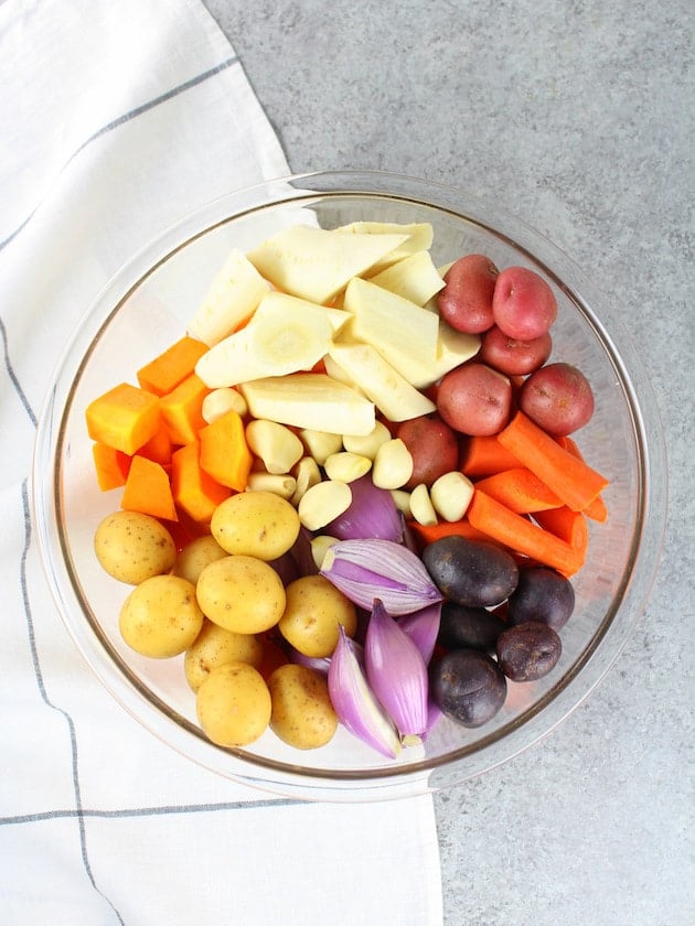 Glass bowl with uncooked fall vegetables.