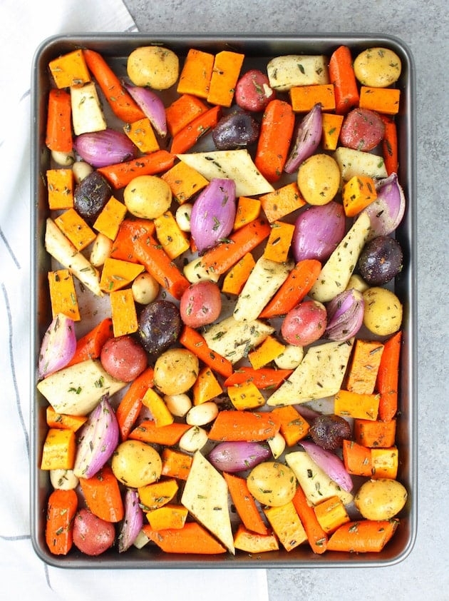 Vegetables on baking sheet ready to be roasted.
