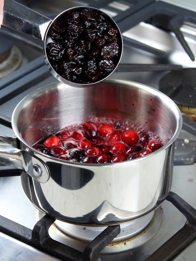 Adding dried cherries to saucepan