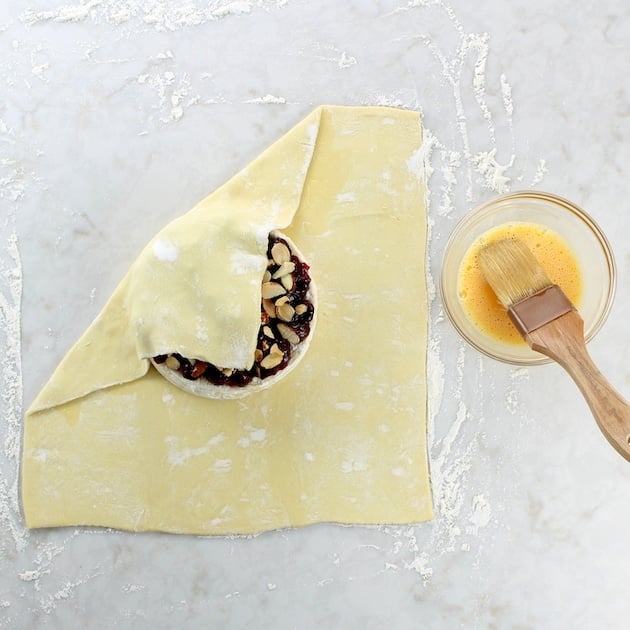 Puff pastry folded over brie with cranberry sauce