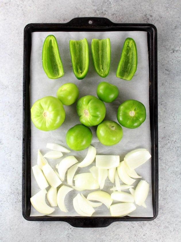 Salsa Verde Recipe: Onions Peppers and Tomatillos on Baking Sheet