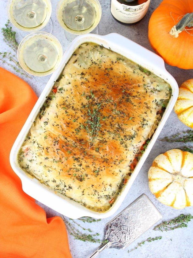 Lighter Easy Turkey Pot Pie casserole dish on table with wine and squash