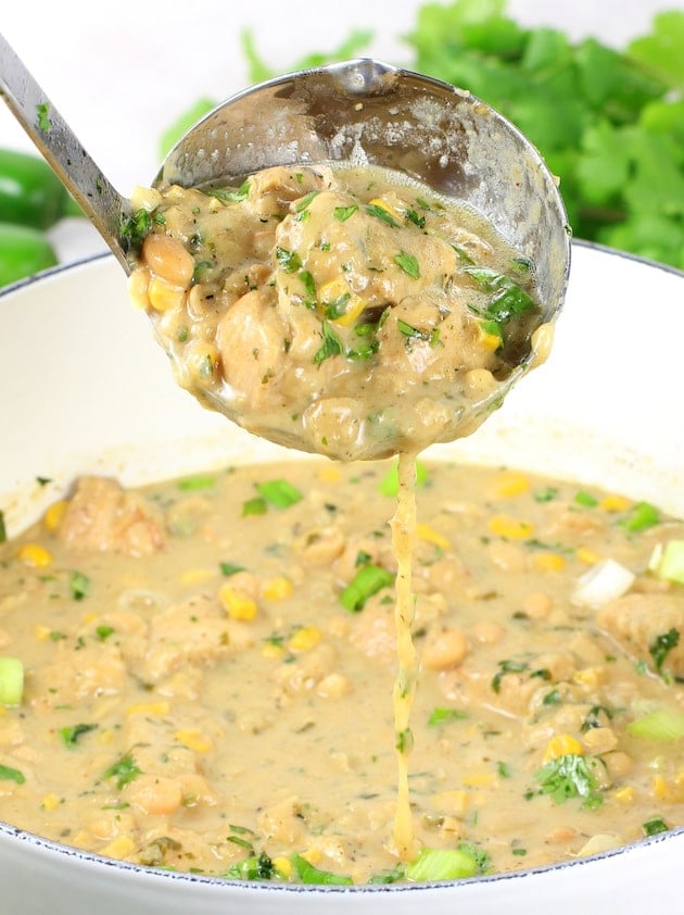  Ladle of chili over pot of white chicken chili