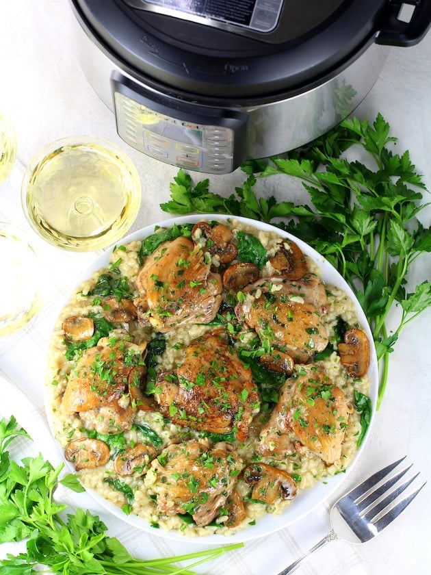 Platter of Chicken Thighs With Risotto next to instant pot