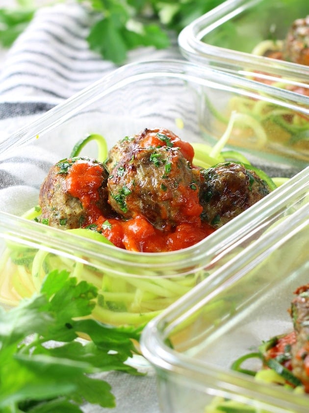 Healthy Meal Prep Baked Turkey Meatballs on zoodles with red sauce in meal prep containers