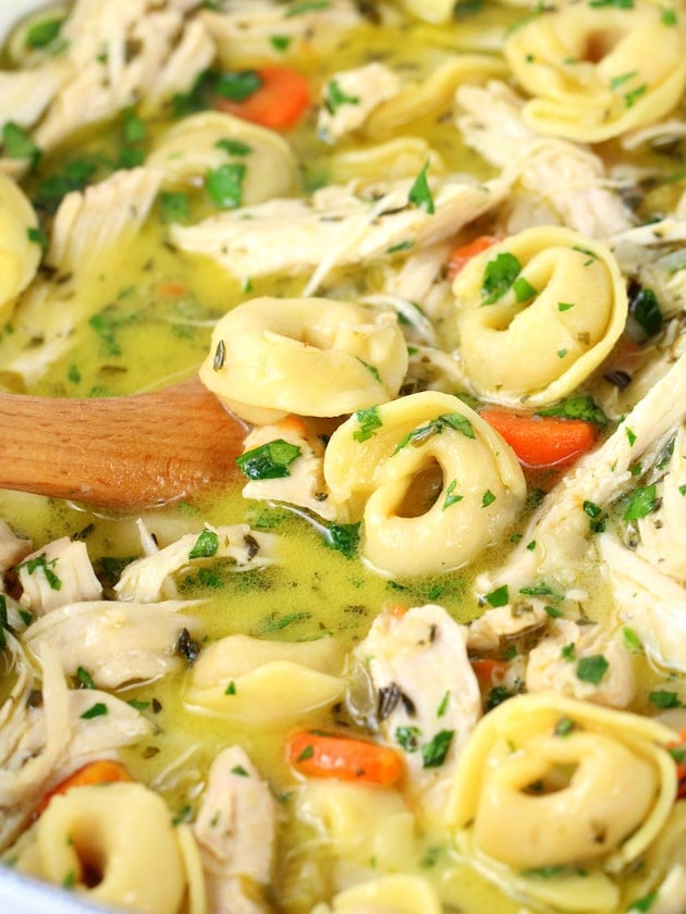 Close up bowl of tortellini soup with chicken