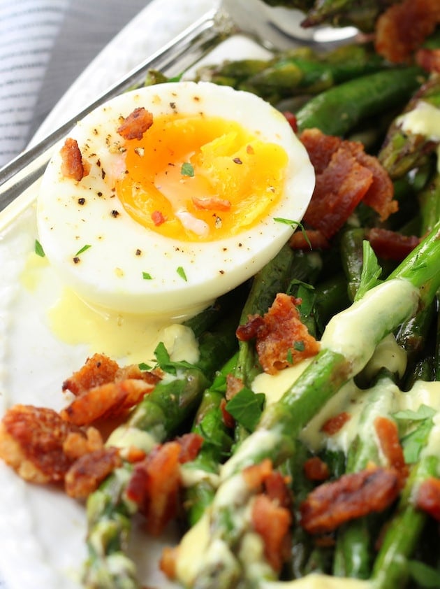 Close cup photo of a runny egg on the salad.