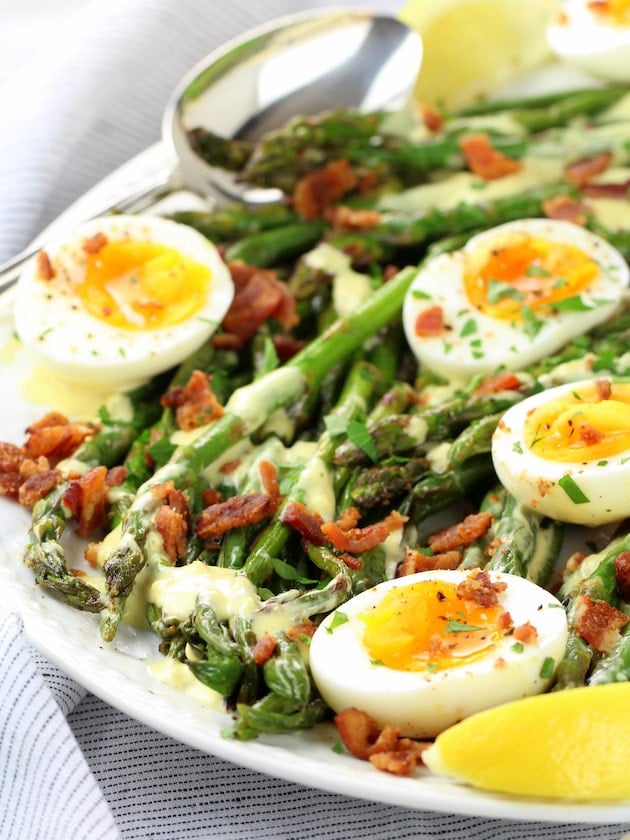 Eye level platter of egg asparagus bacon salad