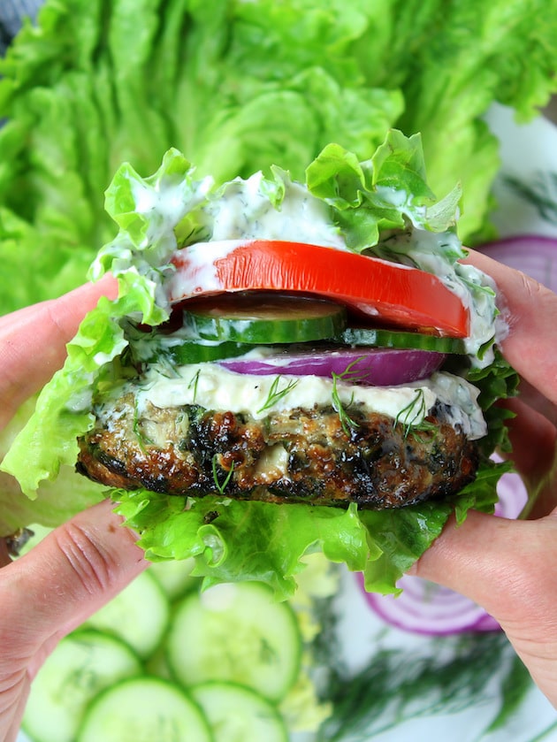 Chicken burger with feta sauce and cucumber in lettuce wrap