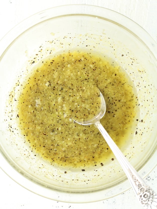 Sauce for lemon pepper wings in a glass mixing bowl