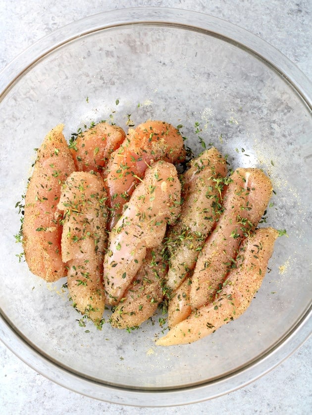 Chicken tenders covered in seasoning 
