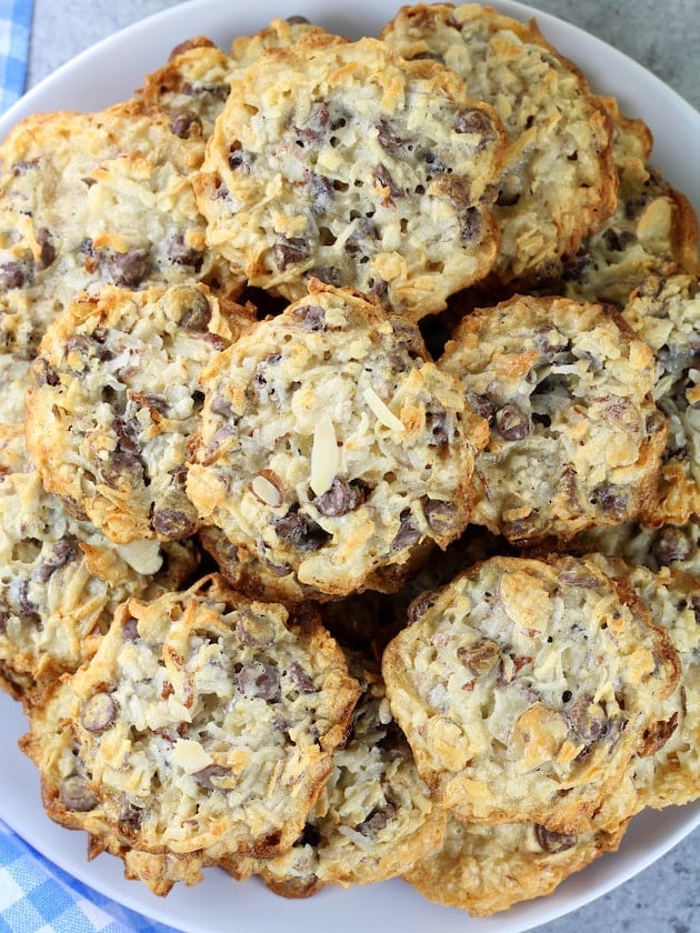 A close up of a plate of almond chocolate chip cookies