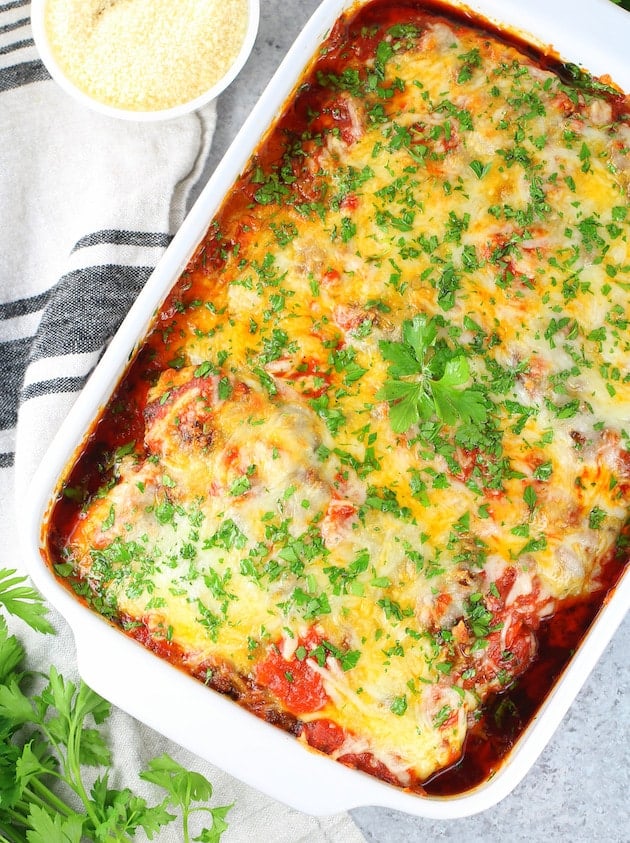 A casserole dish with cheese melted over zucchini lasagna